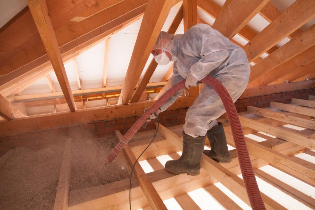 professional spraying Ecowool spray foam insulation in an attic in Utah
