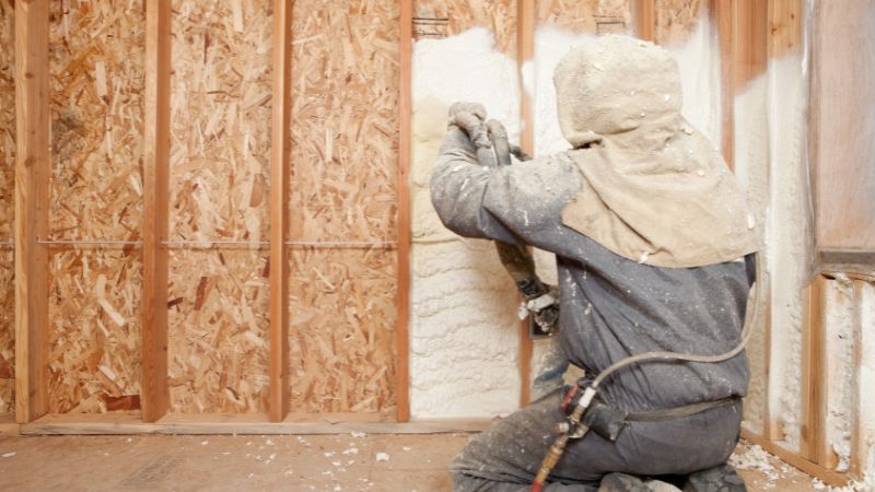 Worker installing spray foam insulation in Northern Utah